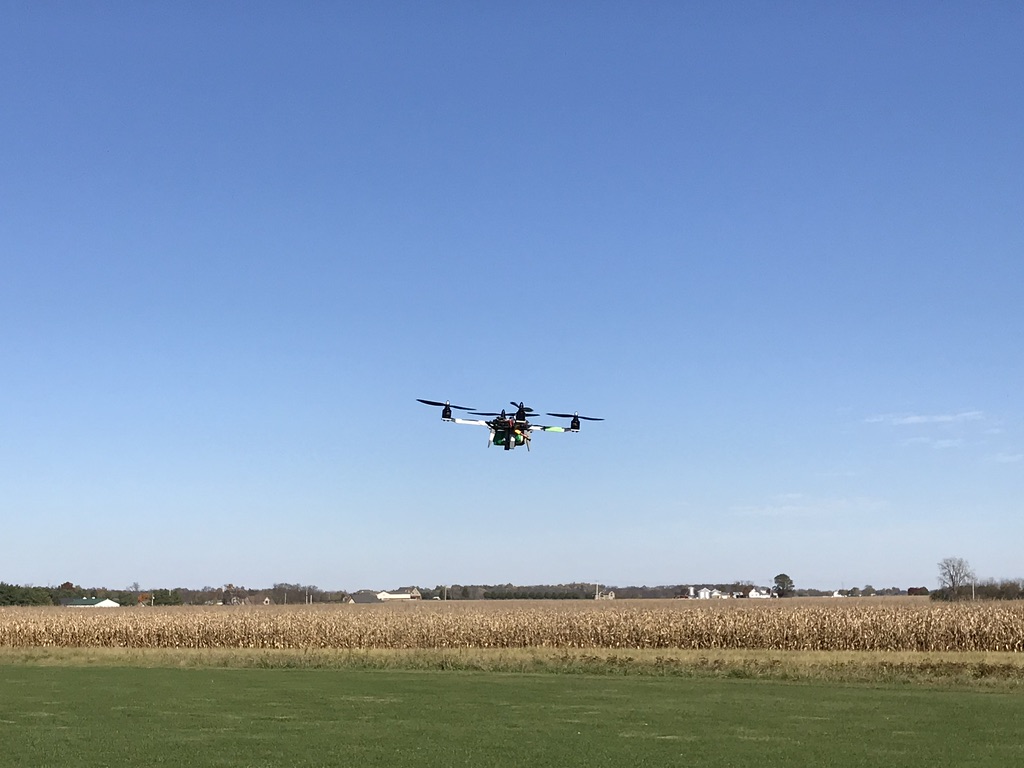 A 3D-Printed Quadcopter flying in front of some cornfields